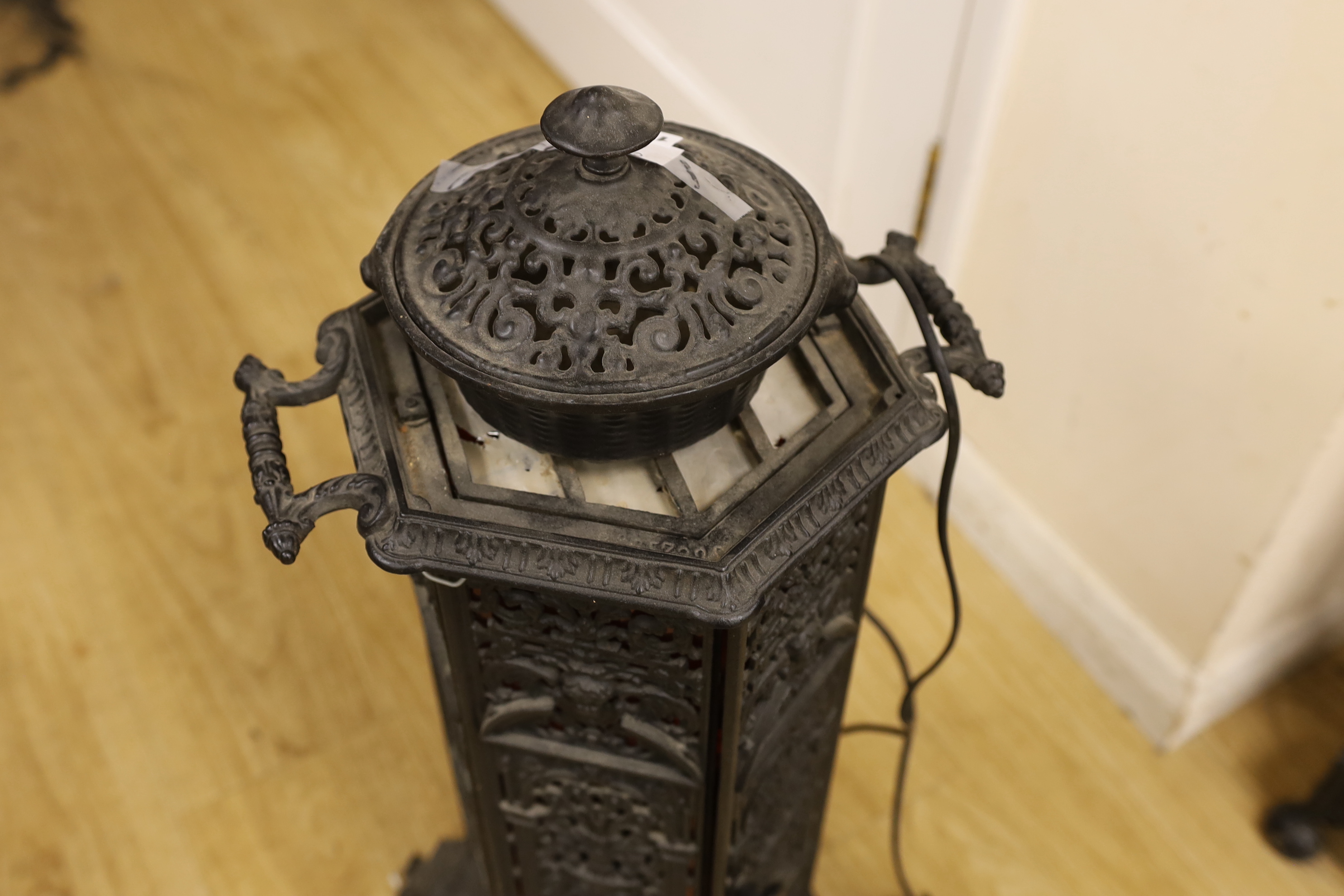 A small cast iron hexagonal stove, 68cm tall